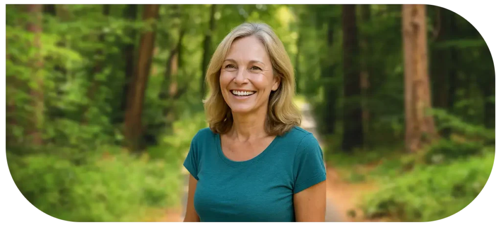 Happy 40-year-old woman enjoying nature, representing optimal hormone balance