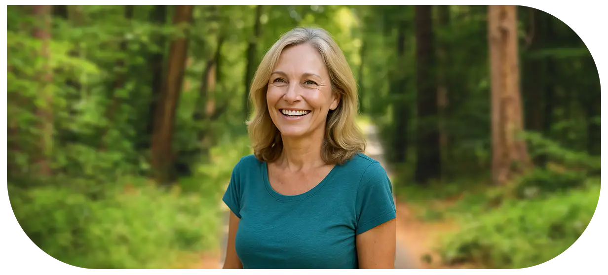 Happy 40-year-old woman enjoying nature, representing optimal hormone balance